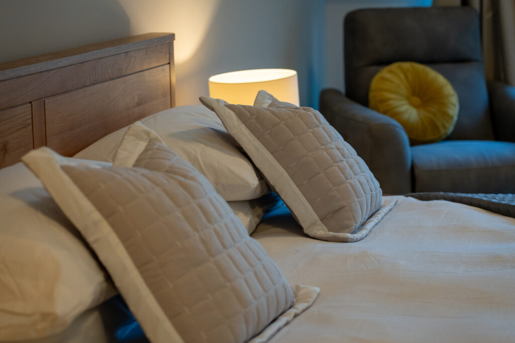 Photo of a cushion on a luxury bed at The Sleeping Giant Hotel in Wales